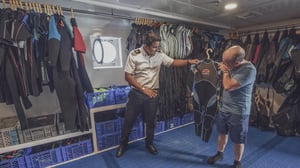 People at the Snorkeling equipment area of the Galapagos Legend