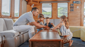 Family enjoying time together inside a Galapagos expedition cruise lounge