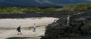 Espinoza Point landscape with rocky beach and volcanoes, hiking tourist