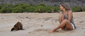 Santa Fe in Galapagos Island with Tourist looking a sea lion on the beach