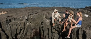 Egas port rocky terrain and sea, conversation betwen guide and tourist