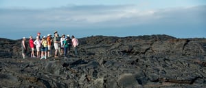 Sullivan bay in Santiago Island have a solid volcanic lava with tourist exploring the terrain