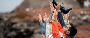 Travelers raising their hands at South Plaza Island.