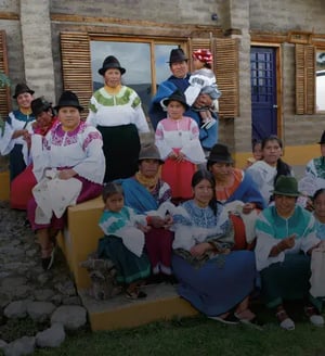 Ecuador Land tours: GO2 Package Galapagos Cruise & Andean cross-culture Experience - A Fusion of Nature and Culture: Indigenous people in front of a house in Karanki